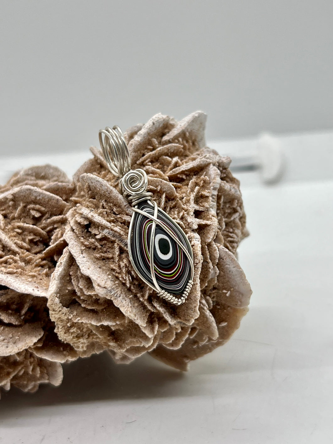 Hand Carved Fordite Sterling Silver Wire Wrap Pendant