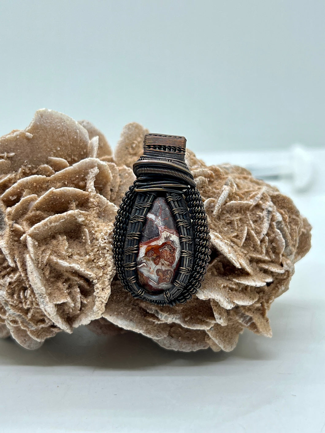 Hand Carved Crazy Lace Agate Oxidized Copper Wire Wrap Pendant